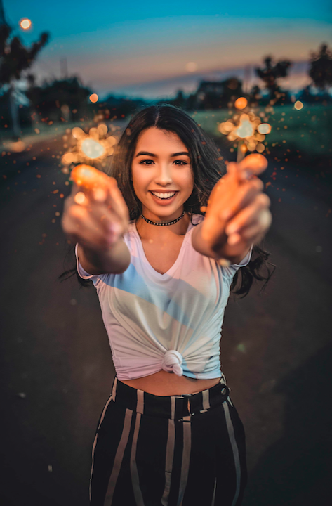 Girl holding sparklers. Photo by Renato Abati from Pexels.com