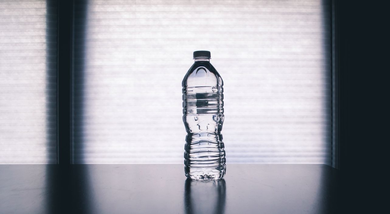 Plastic water bottle on table. Photo by Steve Johnson from Unsplash