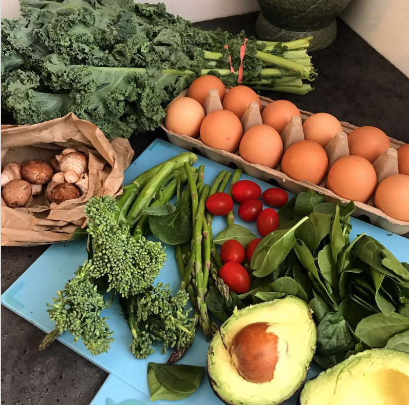 Fresh produce and vegetables on a wooden table.