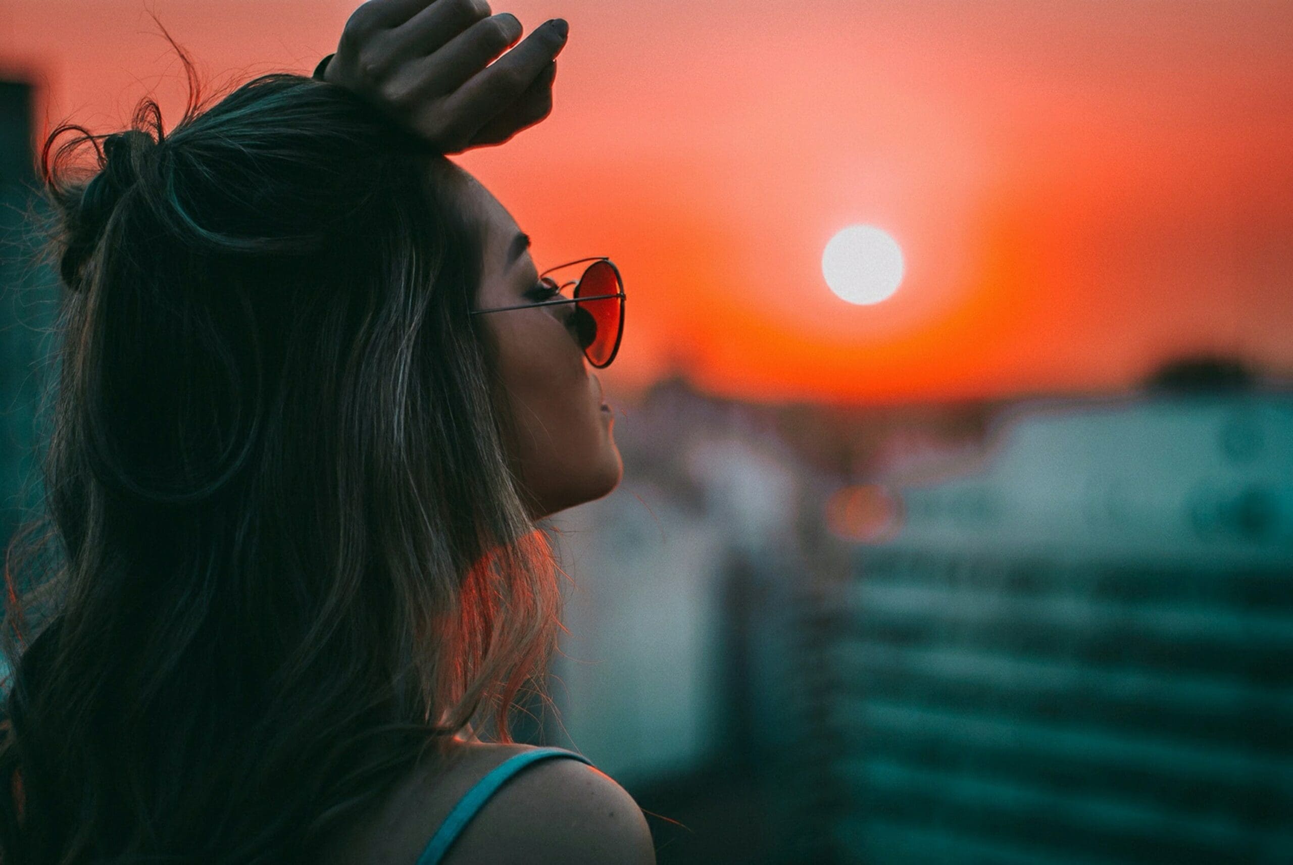 Girl looking into setting sun
