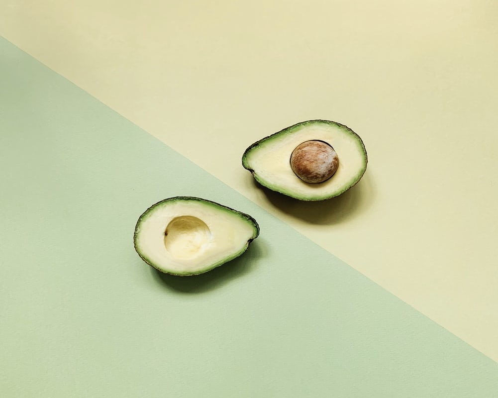 Avocados on a green two tone background