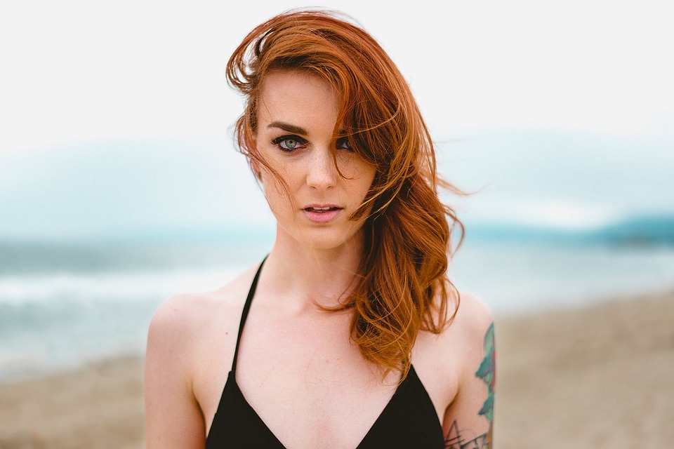 woman with red hair on beach