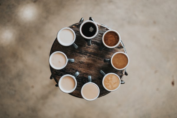 A range of different coffee drinks placed in a circle showing the colours of each drink