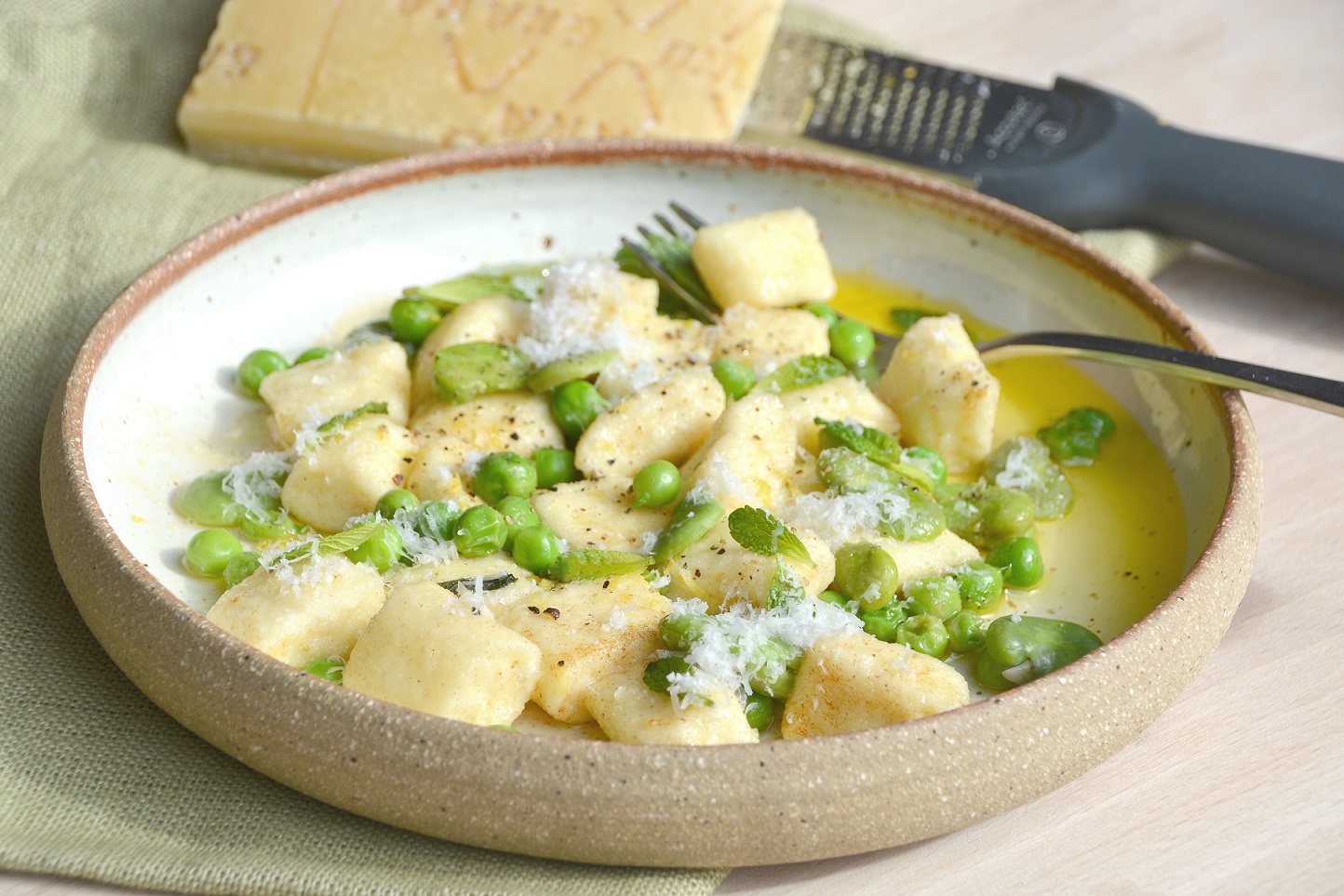Close up of gnocchi with peas and mint