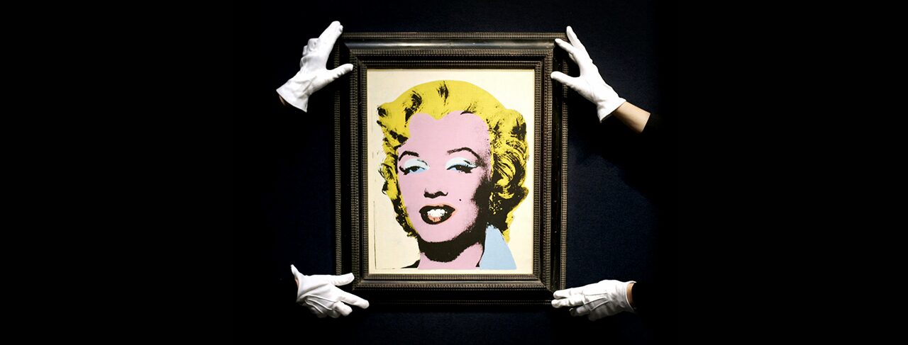 two sets of white gloved hands holding an Andy Warhol print of Marylin Monroe