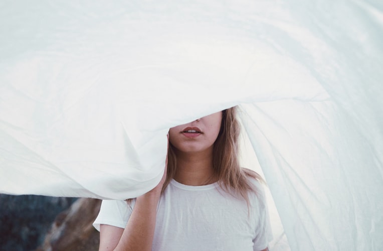 woman wiht white sheet over her head