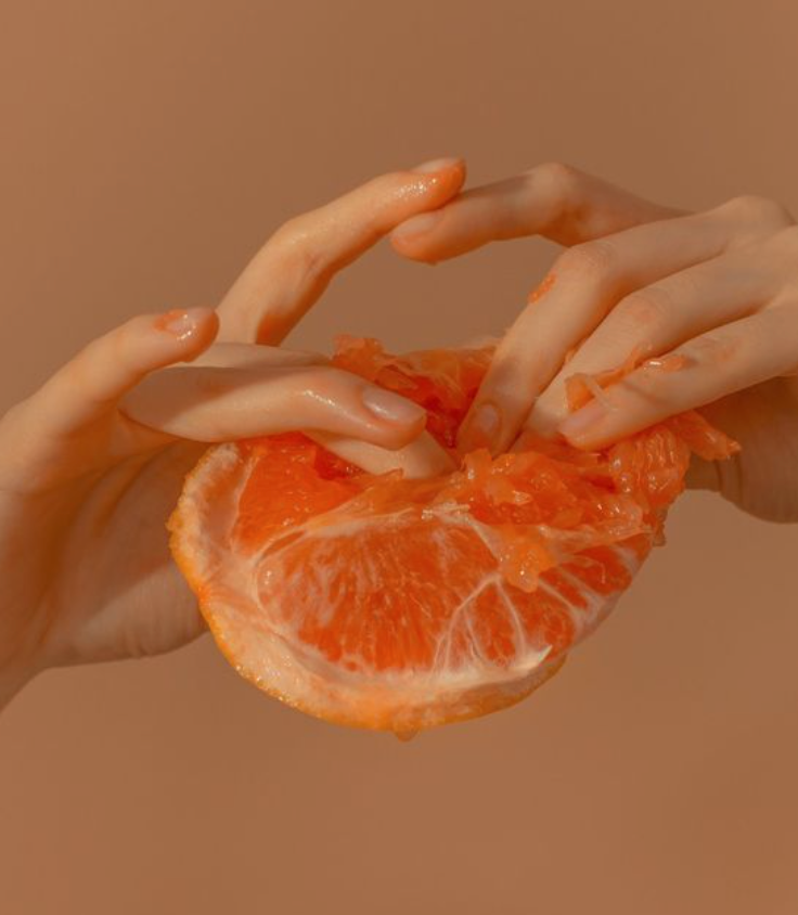 Fingers squeezing grapefruit - sex coach