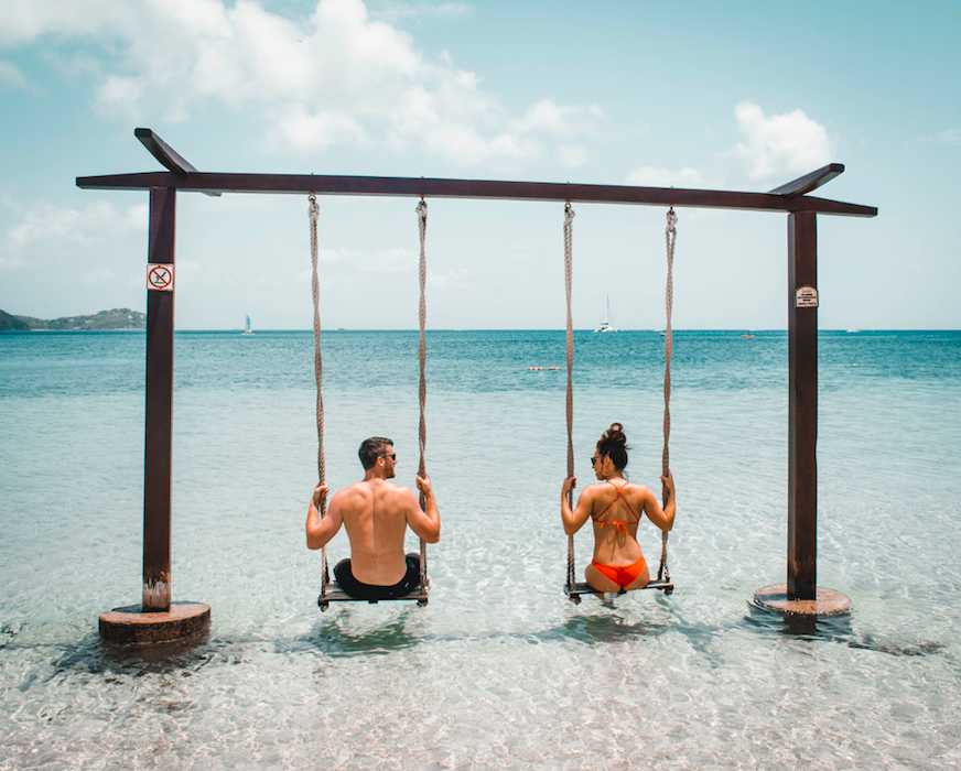 Couple on swings in water