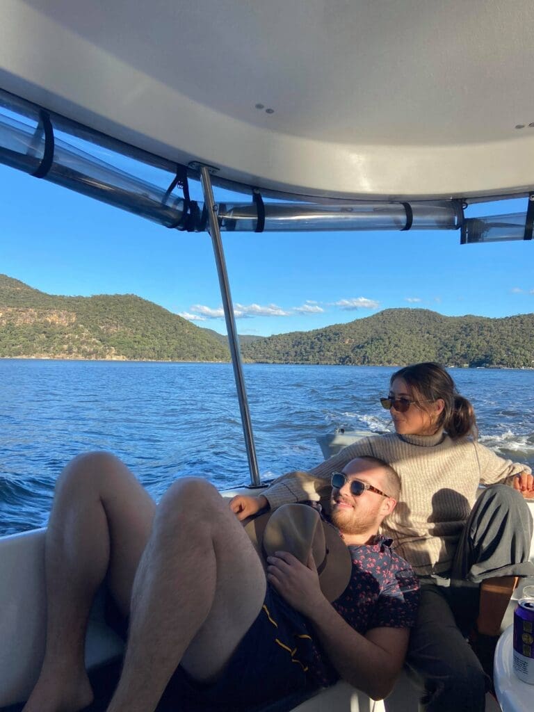 Man and woman lazing about on back of boat