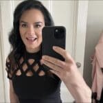 brunette woman in black patterened top